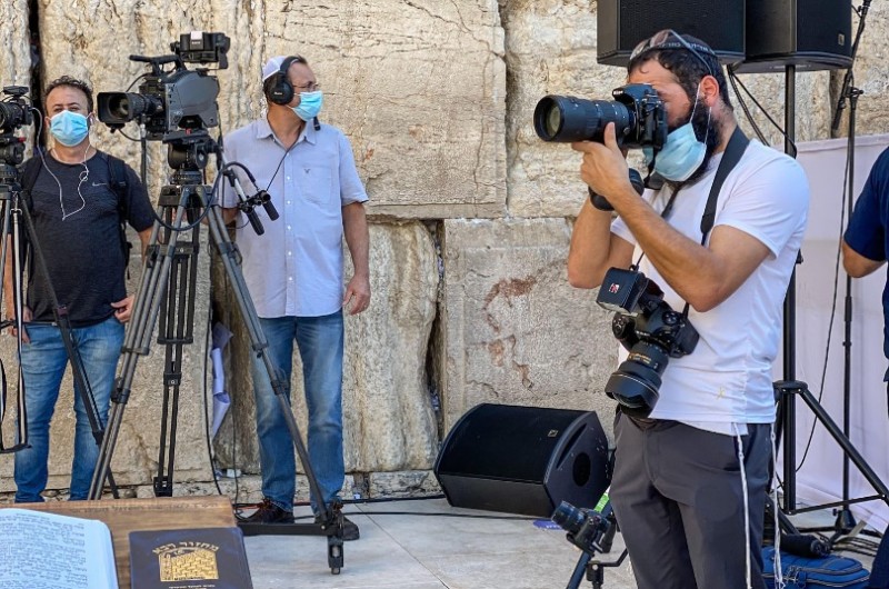 כלי תקשורת רבים סיקרו היום את ברכת הכהנים ההיסטורית ברחבת הכותל המערבי - בה השתתפו רק כ-200 איש, כאשר חצי מיליון נוספים צופים בשידור חי. בתמונה: הצלם החב