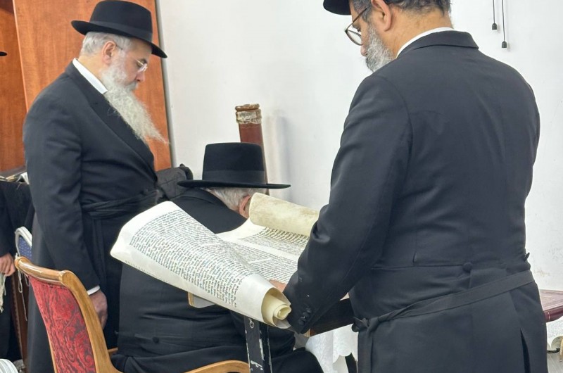 מזכיר בי״ד רבני חב״ד ורב שכונת נחלת הר חב״ד בקרית מלאכי הרב יצחק יהודה ירוסלבסקי שליט״א, לצד בנו הרב בן ציון, בשמיעת מגילת אסתר - במקלט בית הכנסת 